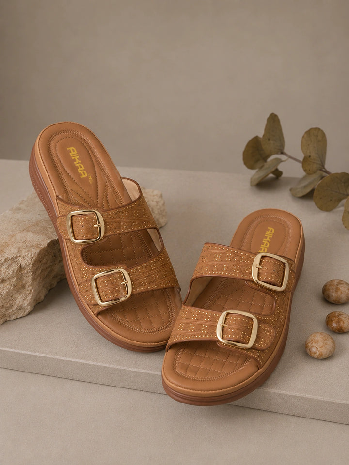 Pair of brown sandals with gold buckles on a neutral background