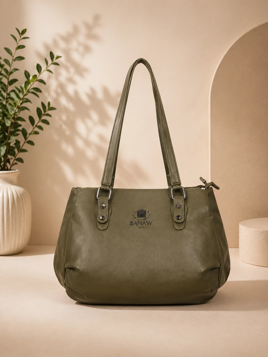 Green handbag on a beige surface with a neutral background