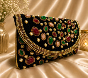 Decorative clutch bag with gemstone embellishments on a satin surface Aikaa Fashion